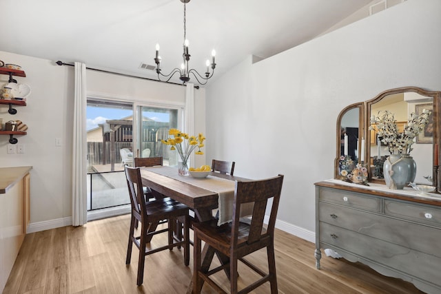 dining area with baseboards, visible vents, lofted ceiling, light wood-style flooring, and a notable chandelier