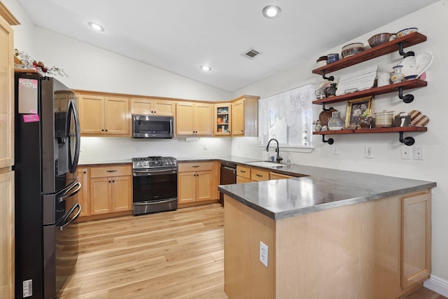 kitchen featuring visible vents, light brown cabinets, a sink, appliances with stainless steel finishes, and a peninsula