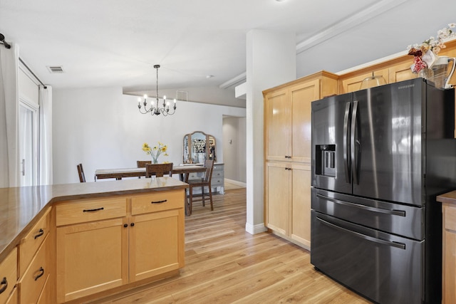 kitchen featuring light brown cabinets, visible vents, fridge with ice dispenser, a notable chandelier, and light wood-type flooring