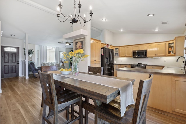 dining room with visible vents, lofted ceiling, recessed lighting, ceiling fan with notable chandelier, and light wood-style floors