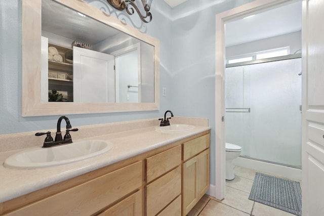 full bathroom with tile patterned floors, a stall shower, and a sink