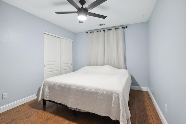 bedroom featuring visible vents, baseboards, a closet, and hardwood / wood-style floors