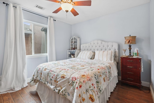 bedroom featuring visible vents, baseboards, and wood finished floors