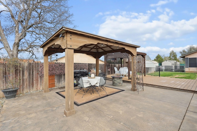 view of patio featuring a gazebo, outdoor dining area, and a fenced backyard