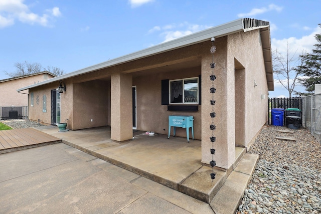 back of house featuring a patio area, stucco siding, and fence