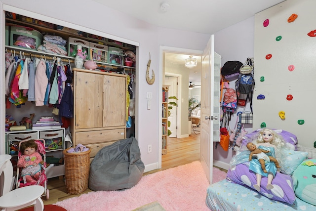 bedroom featuring a closet, baseboards, and wood finished floors