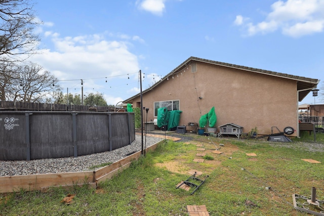 view of yard with fence and an outdoor pool