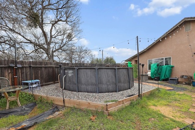 view of yard featuring a fenced in pool and fence