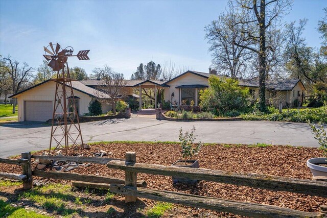 view of front of home with a garage and aphalt driveway