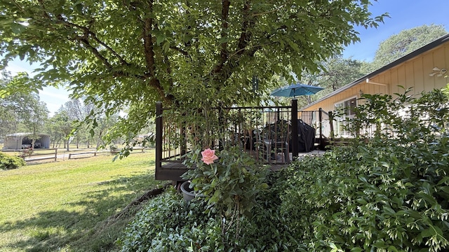 view of green lawn featuring a deck