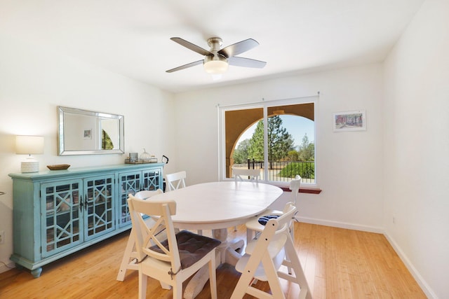 dining area featuring a ceiling fan, light wood-type flooring, and baseboards