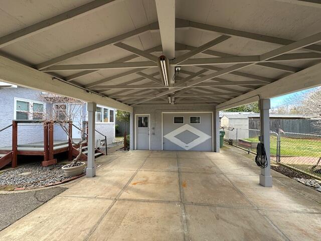 view of patio with fence and a garage