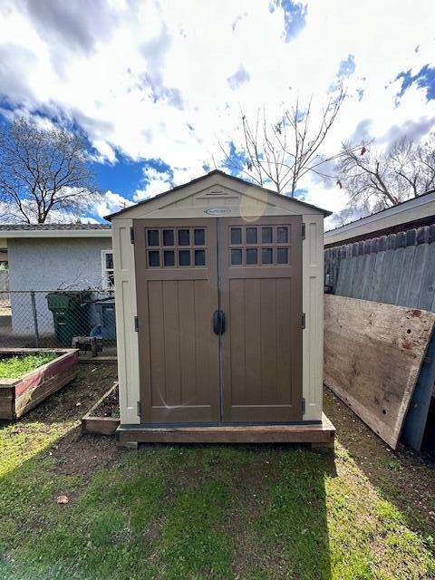 view of shed with fence