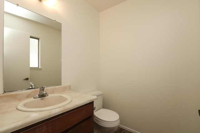 bathroom with toilet and vanity