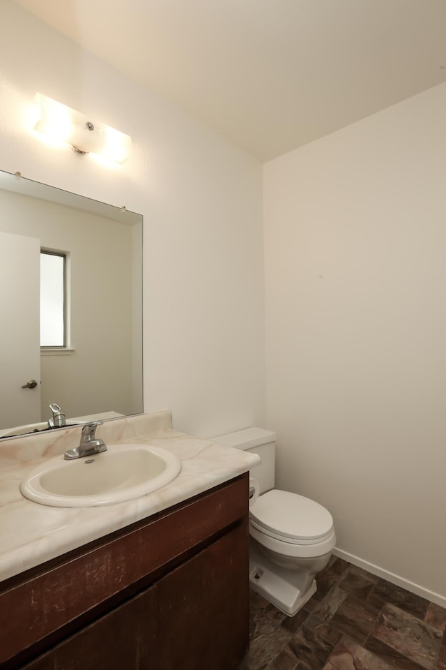 half bath with vanity and toilet