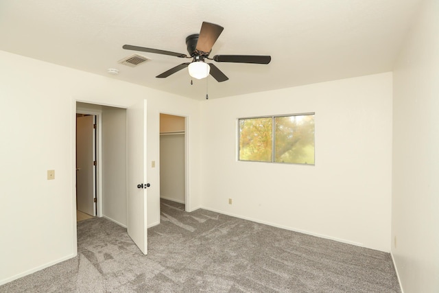 unfurnished bedroom featuring visible vents, carpet floors, baseboards, and ceiling fan