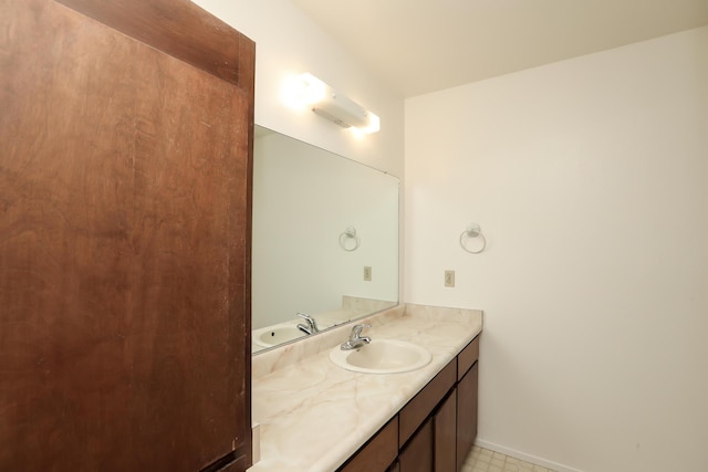 bathroom featuring vanity and baseboards