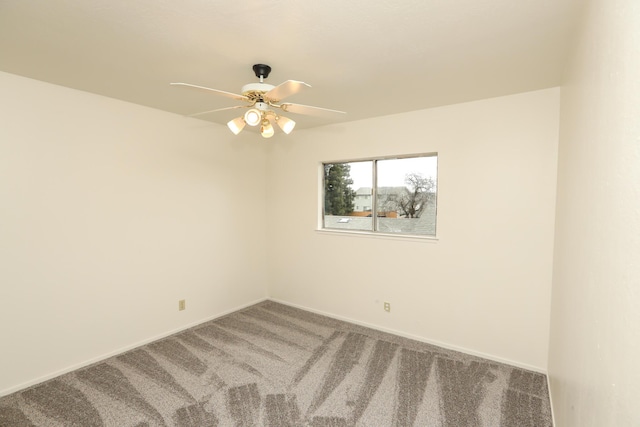 empty room featuring carpet flooring, baseboards, and a ceiling fan