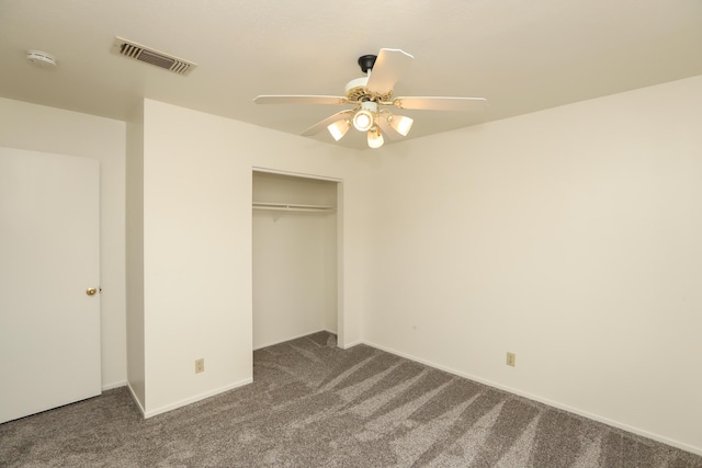 unfurnished bedroom featuring a closet, visible vents, carpet flooring, and ceiling fan