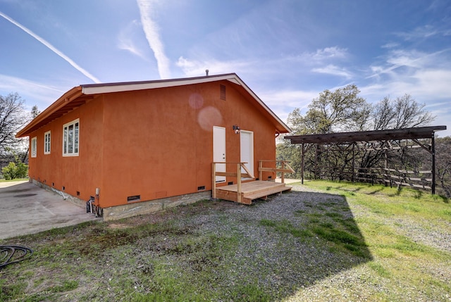 view of side of property with crawl space