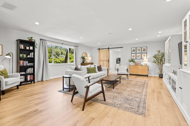 20190 Lupine Dr, Redding, CA 96002 - living room with a barn door, recessed lighting, light wood finished floors, and baseboards