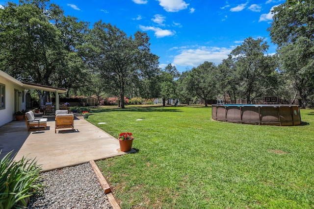 20190 Lupine Dr, Redding, CA 96002 - view of grassy yard featuring a patio, an outdoor pool, view of wooded area, and an outdoor hangout area