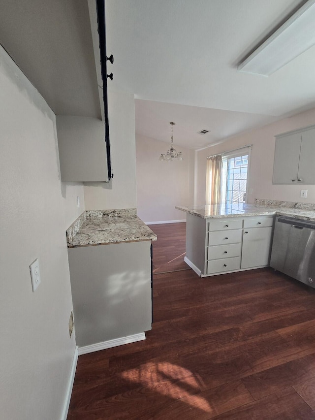 kitchen featuring stainless steel dishwasher, dark wood finished floors, a peninsula, baseboards, and light stone countertops