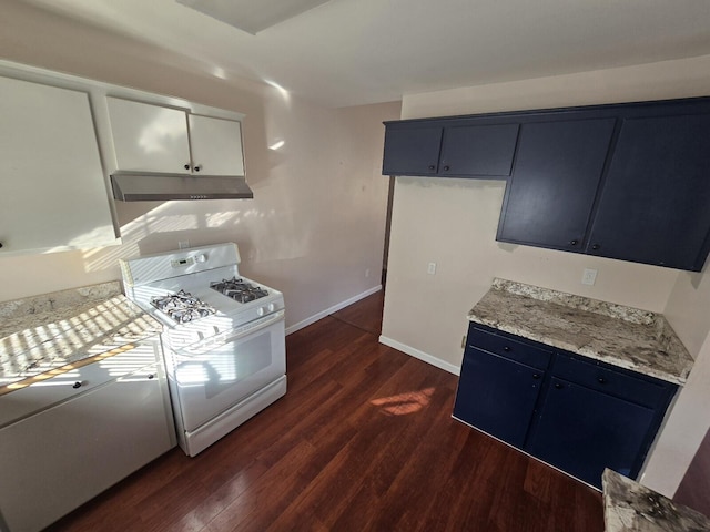 kitchen with baseboards, dark wood-type flooring, under cabinet range hood, blue cabinets, and white gas range