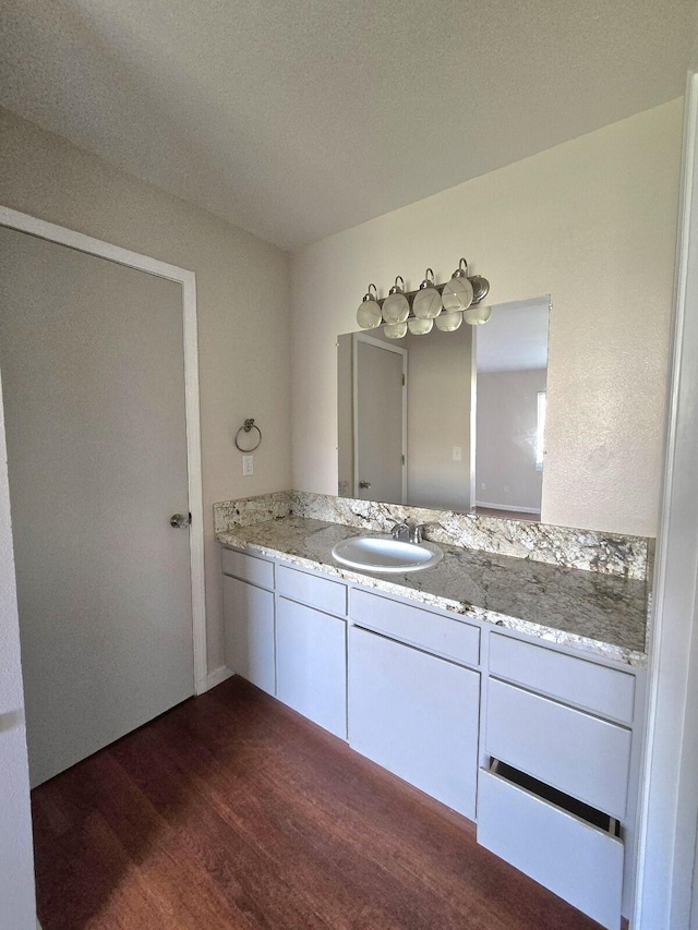 bathroom featuring vanity and wood finished floors