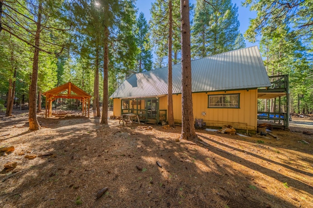rear view of house featuring metal roof and a gazebo