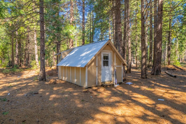 view of shed featuring a view of trees