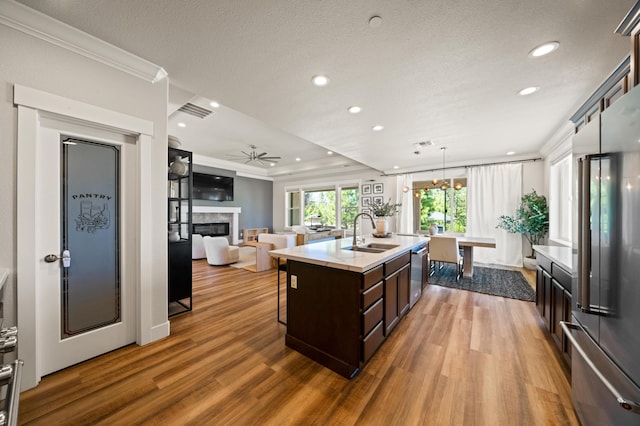 4461 Risstay Way, Shasta Lake, CA 96019 - kitchen featuring light countertops, dark brown cabinets, appliances with stainless steel finishes, and ornamental molding