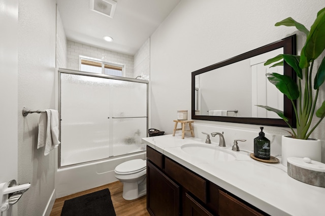 4461 Risstay Way, Shasta Lake, CA 96019 - full bathroom with bath / shower combo with glass door, toilet, wood finished floors, and vanity