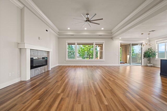 4461 Risstay Way, Shasta Lake, CA 96019 - unfurnished living room featuring wood finished floors, a fireplace, crown molding, baseboards, and ceiling fan