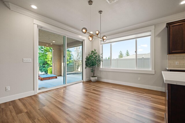 4461 Risstay Way, Shasta Lake, CA 96019 - unfurnished dining area featuring light wood-style flooring, plenty of natural light, and baseboards
