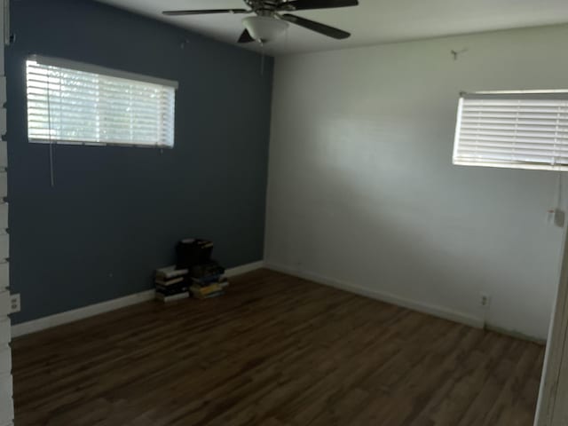 unfurnished room with baseboards, wood finished floors, and ceiling fan
