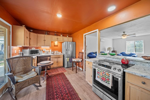 20292 Old Alturas Rd, Redding, CA 96003 - kitchen featuring light brown cabinets, open floor plan, a ceiling fan, stainless steel appliances, and light wood-style flooring