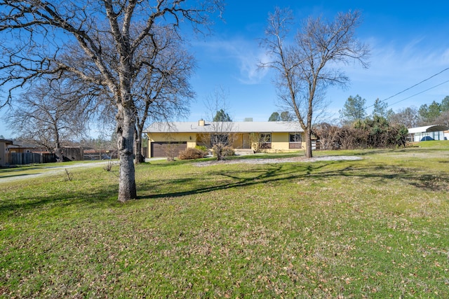 1200 Lema Rd, Redding, CA 96003 - view of front of house featuring a front yard, a chimney, and stucco siding