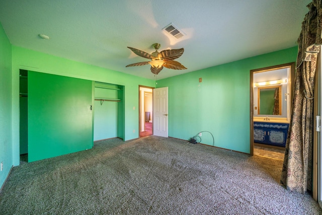 1200 Lema Rd, Redding, CA 96003 - unfurnished bedroom featuring visible vents, a ceiling fan, a closet, connected bathroom, and carpet flooring