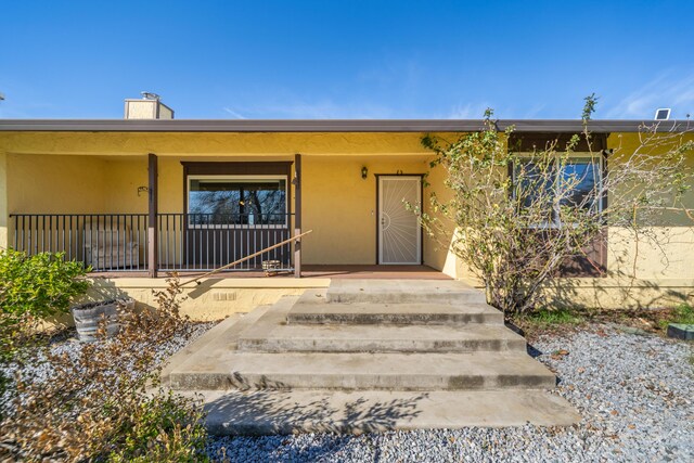 1200 Lema Rd, Redding, CA 96003 - entrance to property with stucco siding and a porch