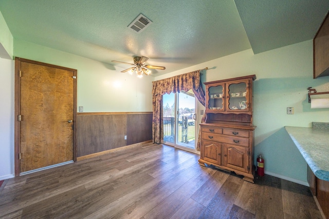 1200 Lema Rd, Redding, CA 96003 - interior space featuring a wainscoted wall, visible vents, a ceiling fan, a textured ceiling, and wood finished floors