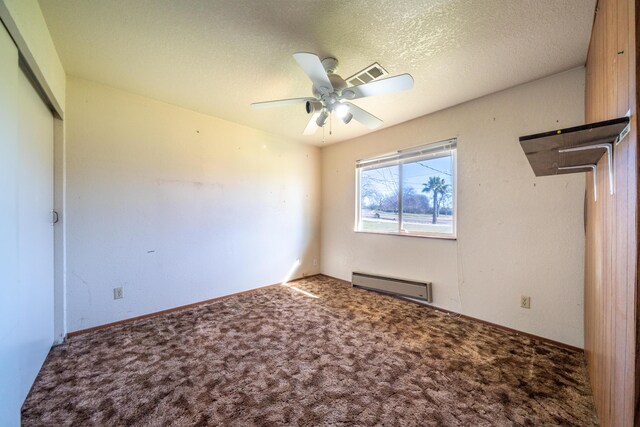 1200 Lema Rd, Redding, CA 96003 - unfurnished bedroom with visible vents, carpet floors, a baseboard radiator, a closet, and a textured ceiling