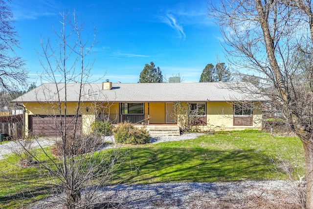 ranch-style house with a porch, a chimney, stucco siding, a front lawn, and a garage