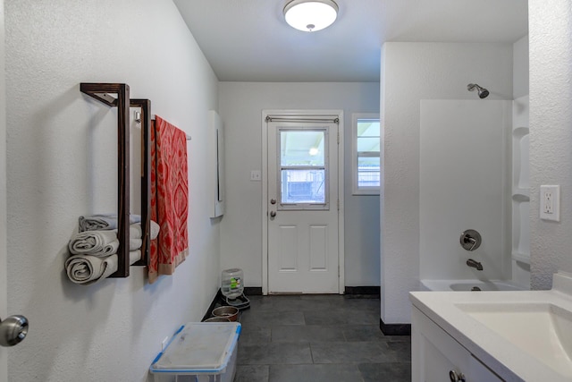 bathroom with shower / washtub combination and vanity