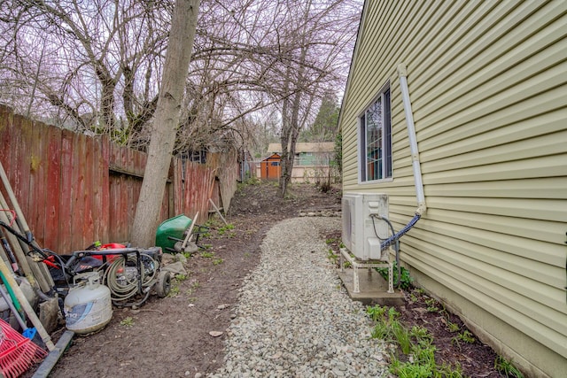 view of yard with ac unit and fence