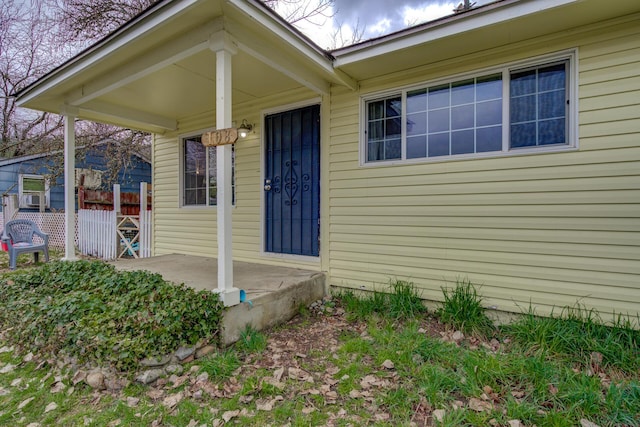 view of exterior entry featuring fence