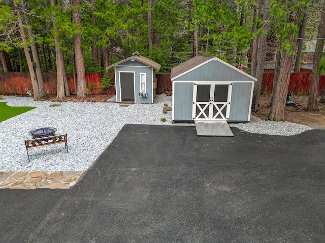 view of shed with fence