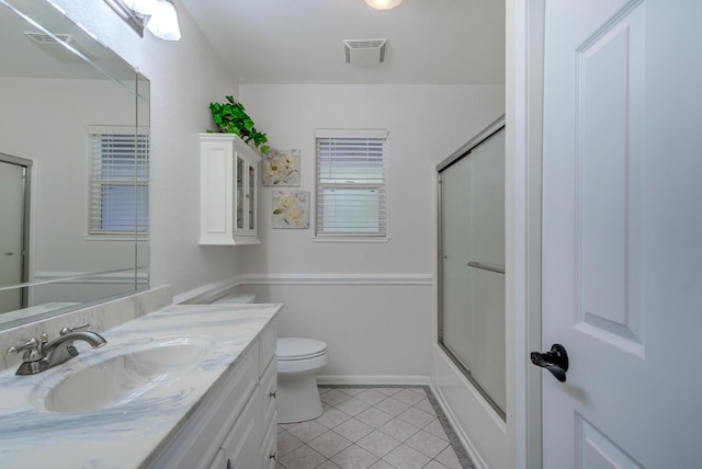 bathroom with visible vents, toilet, tile patterned floors, vanity, and enclosed tub / shower combo