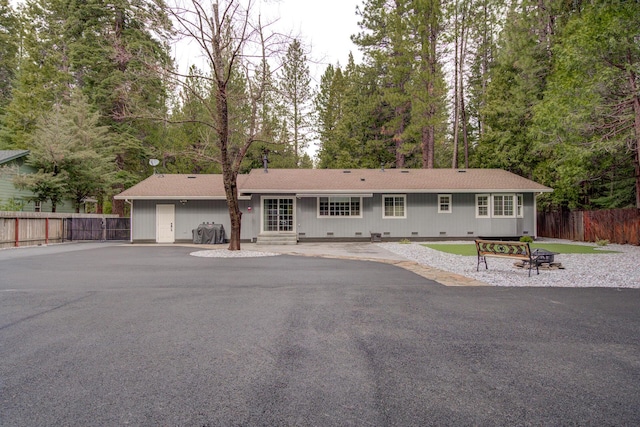 view of front of home with crawl space, fence, and entry steps