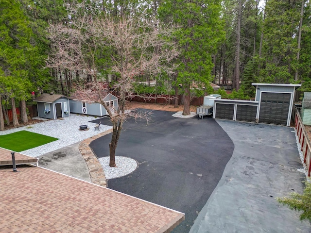 exterior space featuring an outbuilding, a garage, and fence